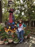 Woman Beside Statue in Garden
