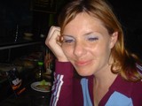 Woman Relaxing at Sushi Restaurant with Smirk