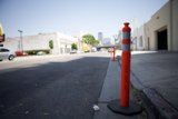 Red and White Traffic Cone on the City Street