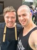 Two Smiling Men in front of a Truck