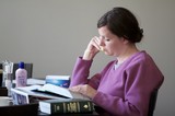 Woman Deeply Focused While Studying Medical References