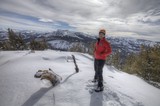 Summit Victory: Mountaineer Atop Snowy Sierra Peak