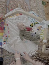 Baby's Playtime Under Colorful Activity Arch