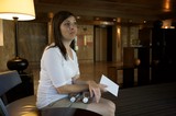 Woman Waiting in Hotel Lobby with Water Bottles