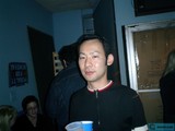 Black shirted man enjoying tea with friends