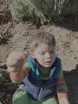 Young Child Playing Outdoors in Garden Setting