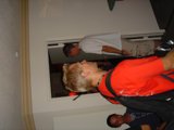 Red shirt man standing by the door