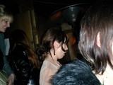 Black-Haired Woman in Leather Jacket at Pub