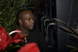 DJ SS sits among flower arrangements