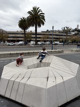 Children Playing on Modern Urban Sculpture Installation