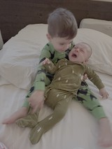Big Brother Comforting Crying Baby Sibling