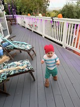 Toddler Exploring Decorated Deck During Outdoor Party
