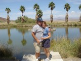 Couple Embracing at Desert Oasis Pond