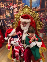 Two Children Visit Santa Claus in His Workshop