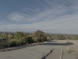 Cracked Rural Road with Mountain Vista