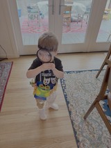 Child Playing Detective with Magnifying Glass