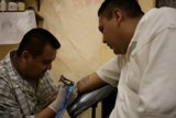 Inking Up: A Tattoo Session with Two Men