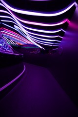 Neon Tunnel with Curved Light Strips and Purple Glow