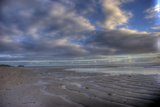 Cloudy Skies Over a Serene Beach