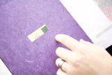 Purple Notebook with a Green Sticker