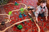 Young Boy Playing with Wooden Train Set on Christmas