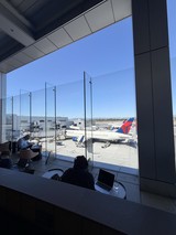 Airport Lounge Workspace with Delta Aircraft on Tarmac