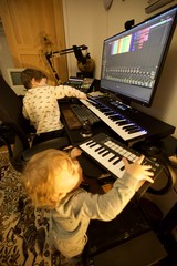Young Brothers Making Music Together in Home Studio