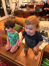 Two Young Boys Playing on Living Room Coffee Table