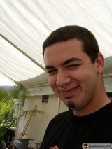 Smiling Man with Nose Ring in Lush Greenery