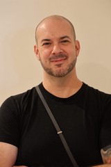 Professional Portrait of Smiling Bald Man in Black