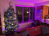 Purple Glowing Christmas Tree in a Festive Living Room