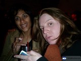 Two women posing with their mobile phones