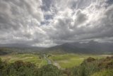 Majestic View of Valley and Mountains under a Cloudy Sky
