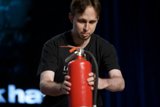 In Case of Emergency: Man With Red Fire Extinguisher