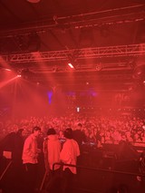 Electronic Music Concert Under Dramatic Red Stage Lighting