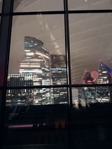 London Financial District Skyline at Night Through Window