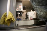 Factory Worker Operating a Lathe Machine