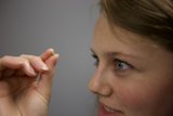 Woman holding a small object