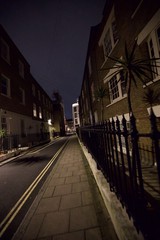 Dark London Street at Night with Iron Railings