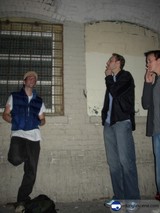 Three Men Posing in Front of a Brick Wall
