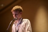 Solo Performance: Young Man Sings into Microphone