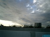 Majestic Cumulus Clouds over City Building