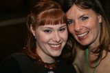 Two Smiling Women Pose Together at Event