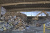 Garbage Pile in Warehouse with Bulldozer
