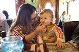 Mother and Child Sharing a Sweet Moment at Restaurant