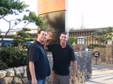 Two Men Standing in front of a Slate Wall