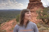 Woman Smiling Atop Red Rock Formation in Sedona