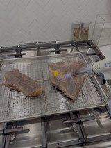 Culinary Torch Caramelizing Meat on Professional Grill