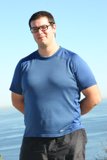 Dave B enjoying the ocean view with his blue shirt and glasses on