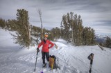 Smiling Mountaineer Rests Atop Snowy Sierra Summit